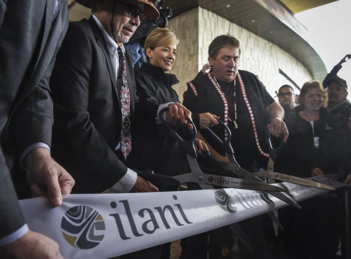 Cowlitz Indian Tribe Chairman William Iyall, left, ilani President and General Manager Kara Fox-LaRose, and Cowlitz tribal member David Barnett cut a ribbon at the casino’s April 24, 2017 grand opening ceremony.