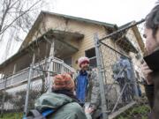 Katelyn Benhoff, lead outreach case manager with Share, left, speaks with Dimitri Coles in front of Share House while performing the annual Point in Time Count on Jan. 24, 2019.