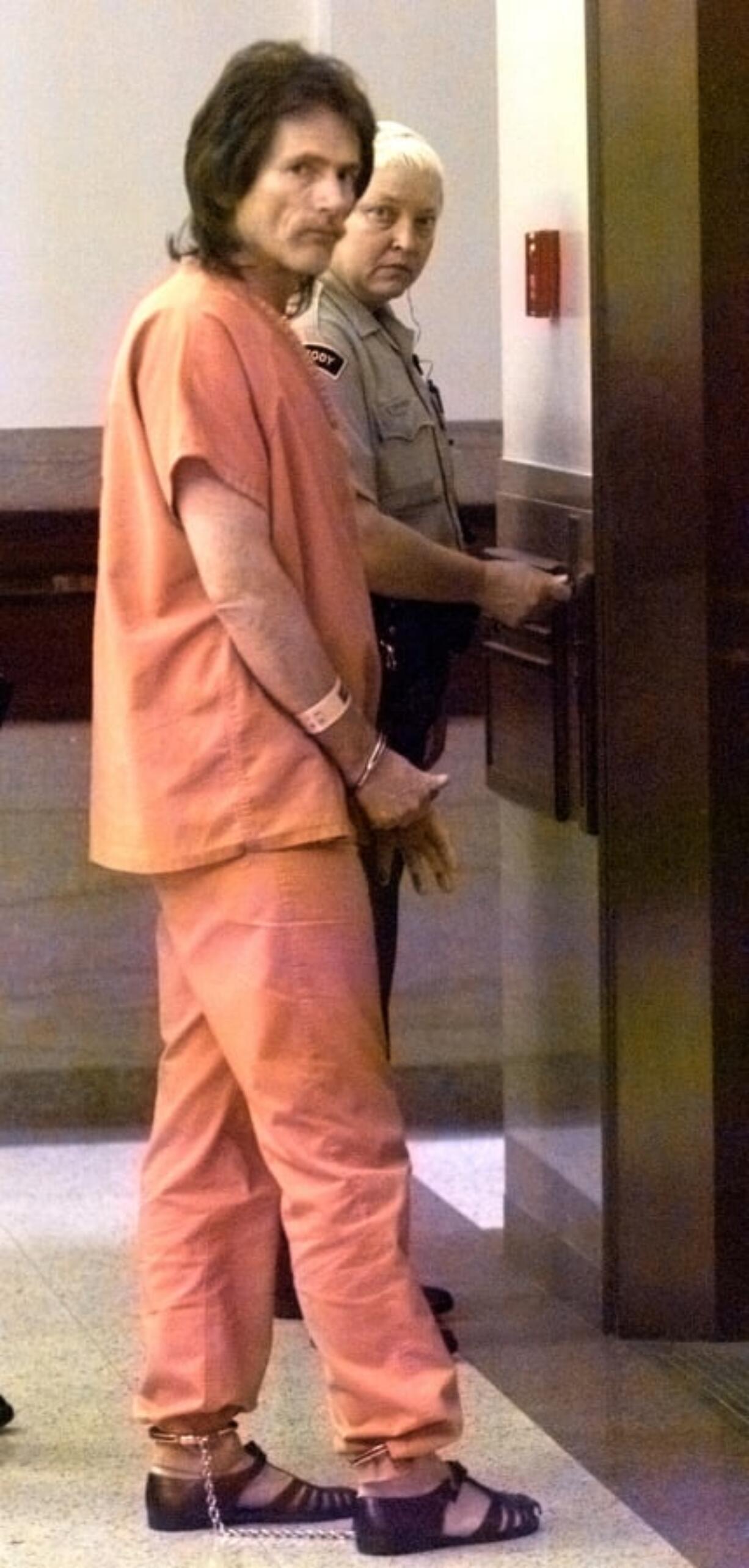 John D. Letellier is led off to prison and a life-without-parole sentence in 1999 after he pleaded guilty and said he wanted to go to prison.