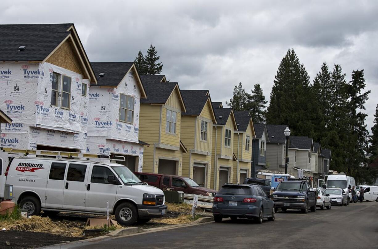 Construction crews work at the Meadows at 58th Street development last month.