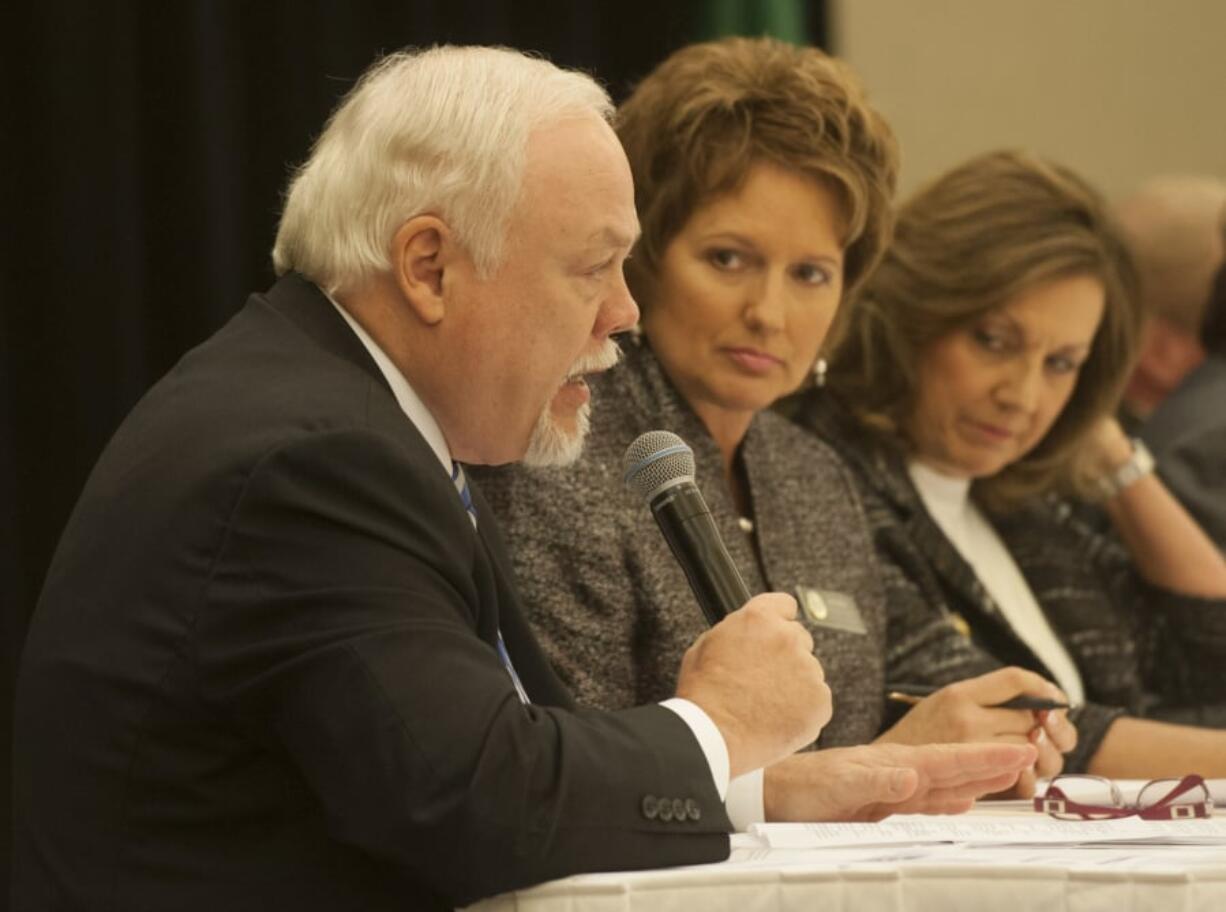 Then State Sen. Don Benton speaks Dec. 15, 2015, at the legislative outlook breakfast as Rep. Liz Pike listens at the Hilton Vancouver Washington.