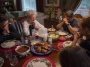 Vivian Church, center, leads a prayer with her grandson, Hal Stokes, right, and his family before dinner at their home in Ridgefield on Friday, May 17, 2019. Church moved in to the finished basement at her grandsonÕs home in 2015. Aside from a full kitchen, she has a whole living area to herself.