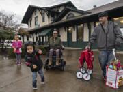 With a handful of gummy bears in one hand, Tobias reacts as the train pulls into the Vancouver rail station on its way to Seattle. Tobias, who was joined by his sister, Arianna Adams, 7, background from left, his mom, Jasmine Adams, and his dad, Matt Adams, was looking forward to taking his first train ride and going on his first vacation.