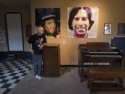 Jazz organist Louis Pain, relaxing in his “man cave” in his home on a Washougal hillside, leans on a Leslie rotating speaker while describing the ultimate cool of the Hammond B-3 organ. Behind Pain are artworks featuring the faces of his wife, Tracy, and himself in younger days.