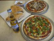 The Punjabi special, clockwise from bottom, a calzone with pepperoni and a N.Y.C. pizza.