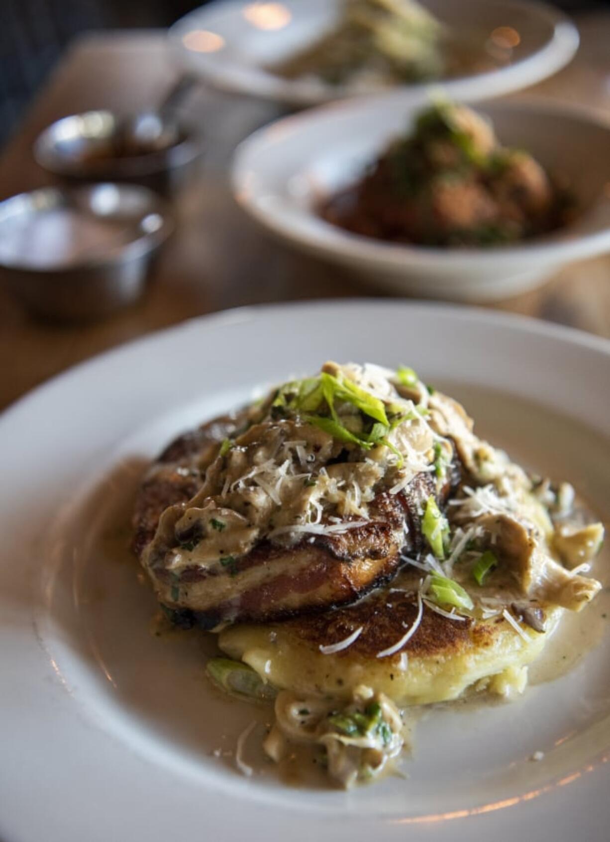 The bacon wrapped meatloaf with a Yukon potato pancake and wild mushroom gravy.