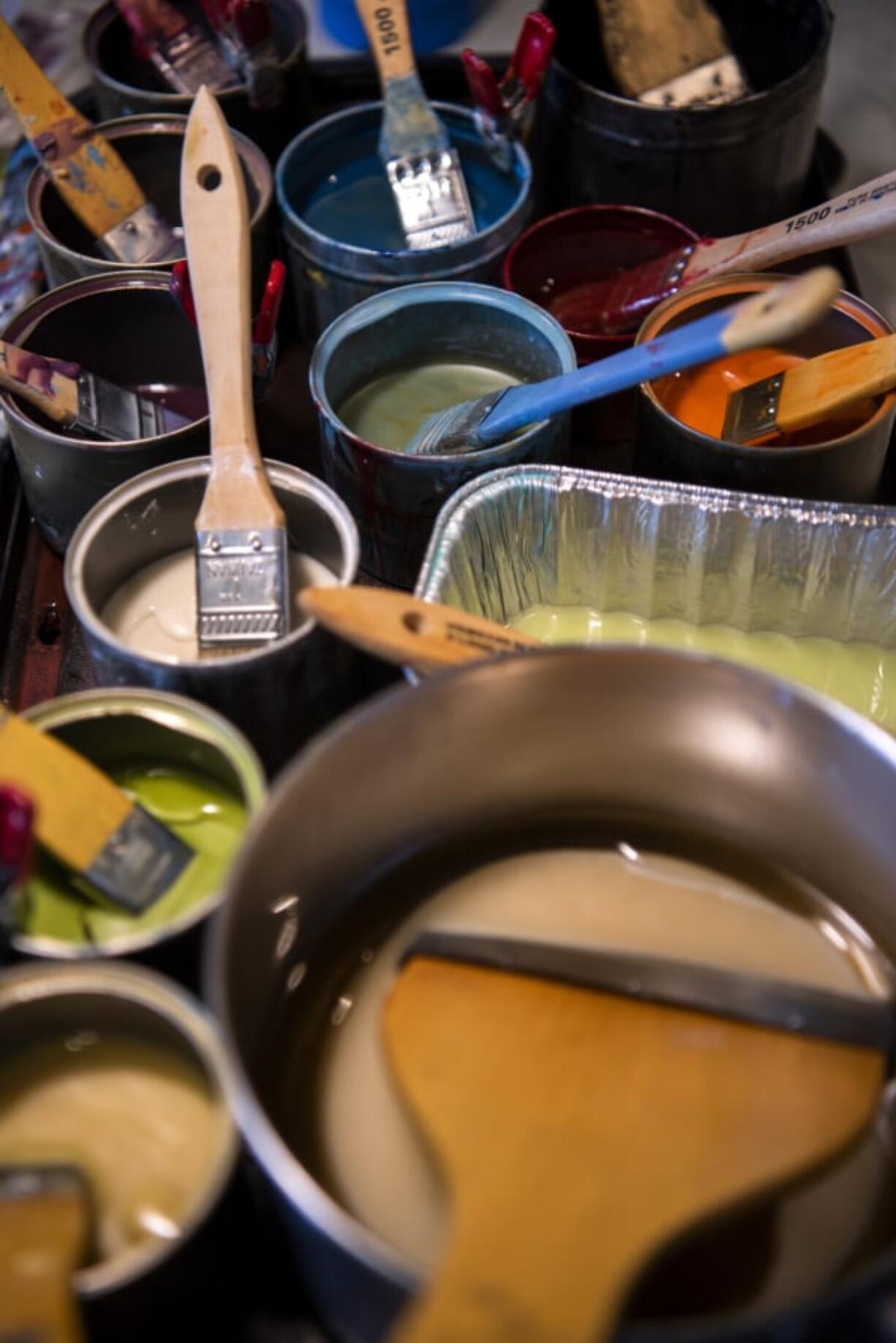 Many colorful mixtures of encaustic (beeswax) and dammar resin sit Tracy Simpson’s home studio in Washougal, ready to go; all she has to do is melt them, or make some more, to start adding colors to her works in progress.