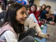 Crestline Elementary School first-grader Avaya Lagers asks high school students who inspires them to make change during their visit to the Vancouver elementary school last week.