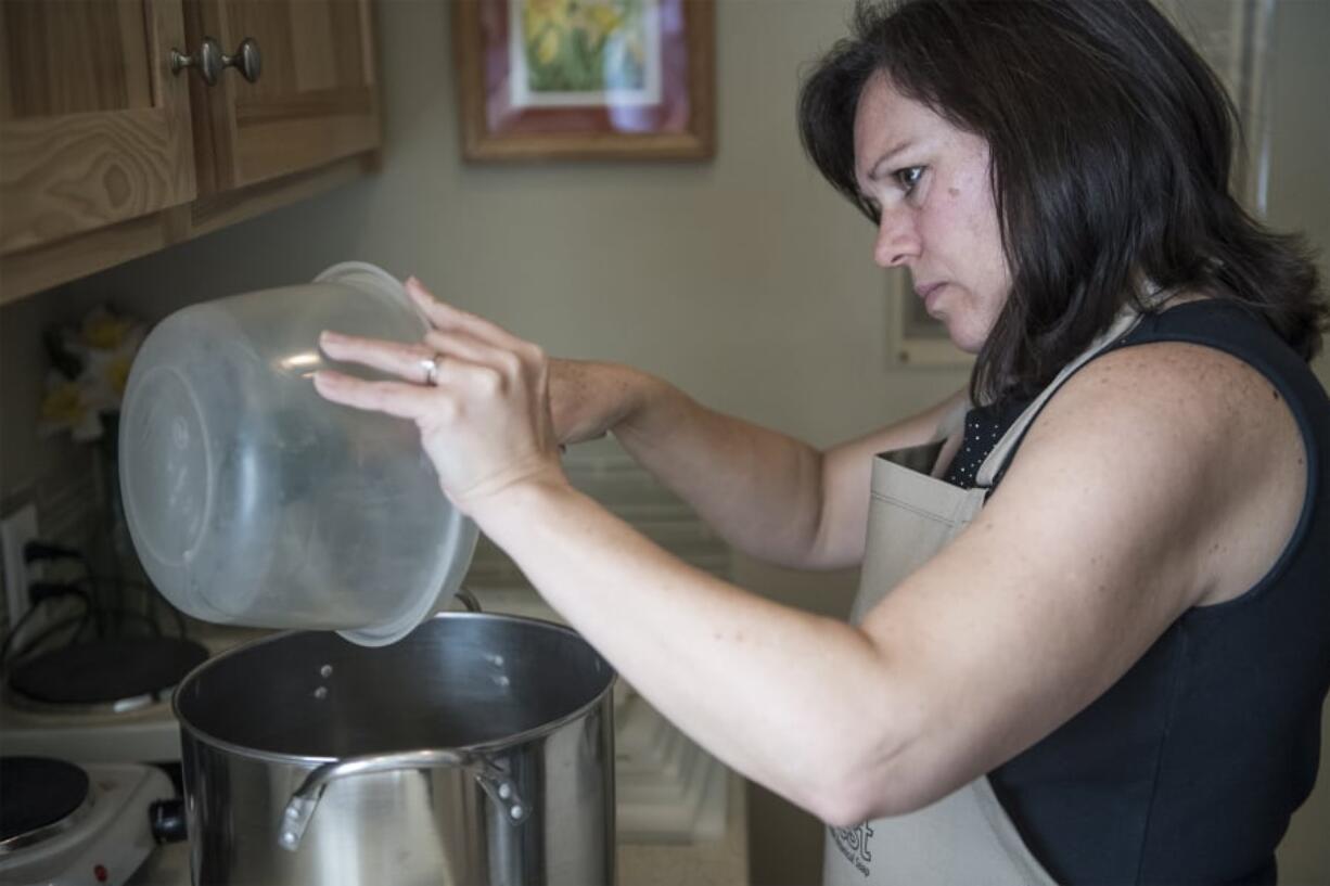 Gail Horn moves oils into a pot to make a new batch of soaps at her shop, The Soap Chest, in Camas on a recent Tuesday.