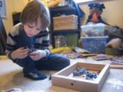 Connor Kassing, 8, assembles a Lego set in his room. “I like the creation,” Connor said of Lego building. “How you can either build a set of any genre you like or you can build whatever you want.