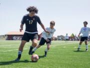 Prairie junior Quentin Roemer dribbles the ball near the sideline during a game against North Thurston at Prairie High School on Saturday, May 4, 2019. Prairie beat North Thurston 3-0 to move on to the next round of the state soccer tournament.