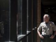 Clark County Sheriff Chuck Atkins takes a peek outside his office Monday afternoon. The sheriff recently sat down with The Columbian to reflect on his first term.