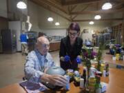 Milt Olsen, a former aviator who served during the Vietnam War, gets a assistance with lunch from Nutrition and Food Services Operations Manager Jenelle Cruz in the Community Living Center’s dining room at VA Portland Health Care System, Vancouver Campus Tuesday afternoon.