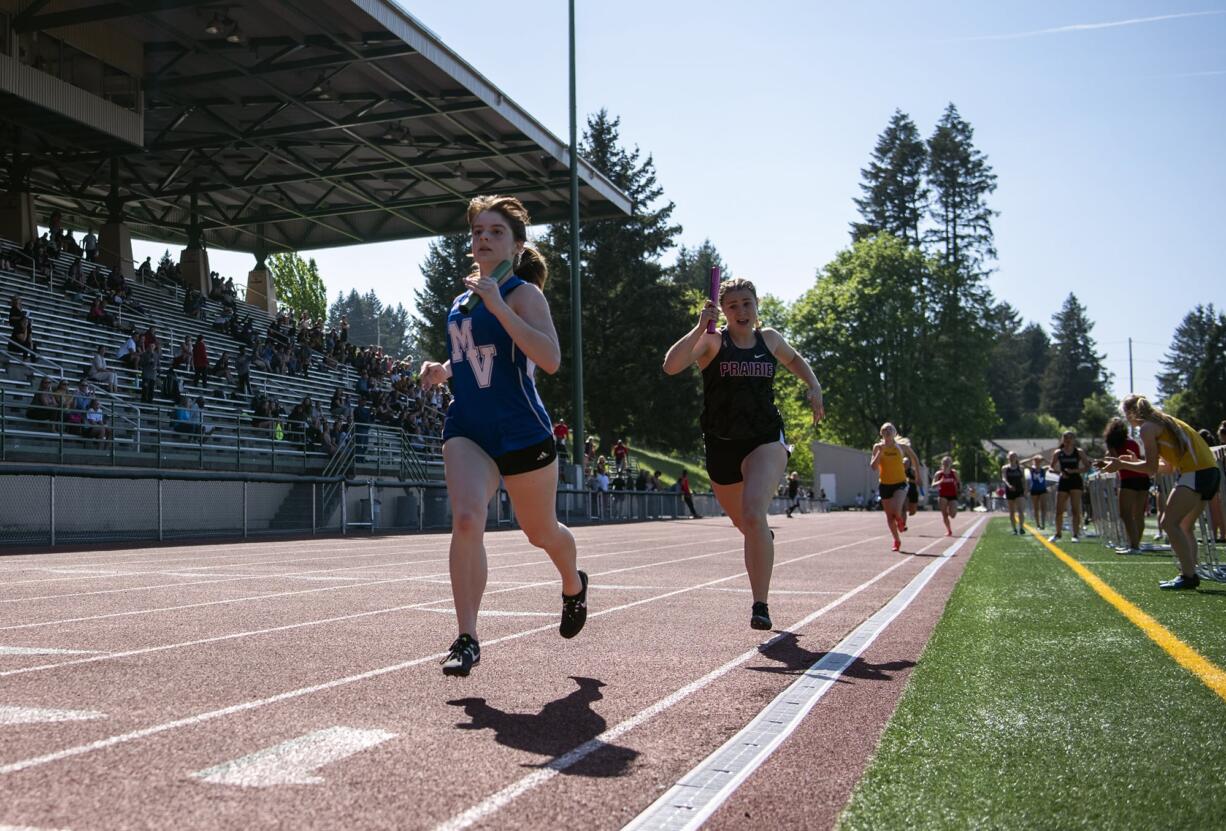 Mountain View's Bella Mathieson, left, and Prairie's Mary Lynn McLeod finish the last leg of the 3A 800 meter relay during the Class 3A and 4A district track and field meet at McKenzie Stadium in Vancouver on Wednesday, May 8, 2019.