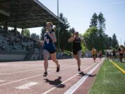 Mountain View's Bella Mathieson, left, and Prairie's Mary Lynn McLeod finish the last leg of the 3A 800 meter relay during the Class 3A and 4A district track and field meet at McKenzie Stadium in Vancouver on Wednesday, May 8, 2019.