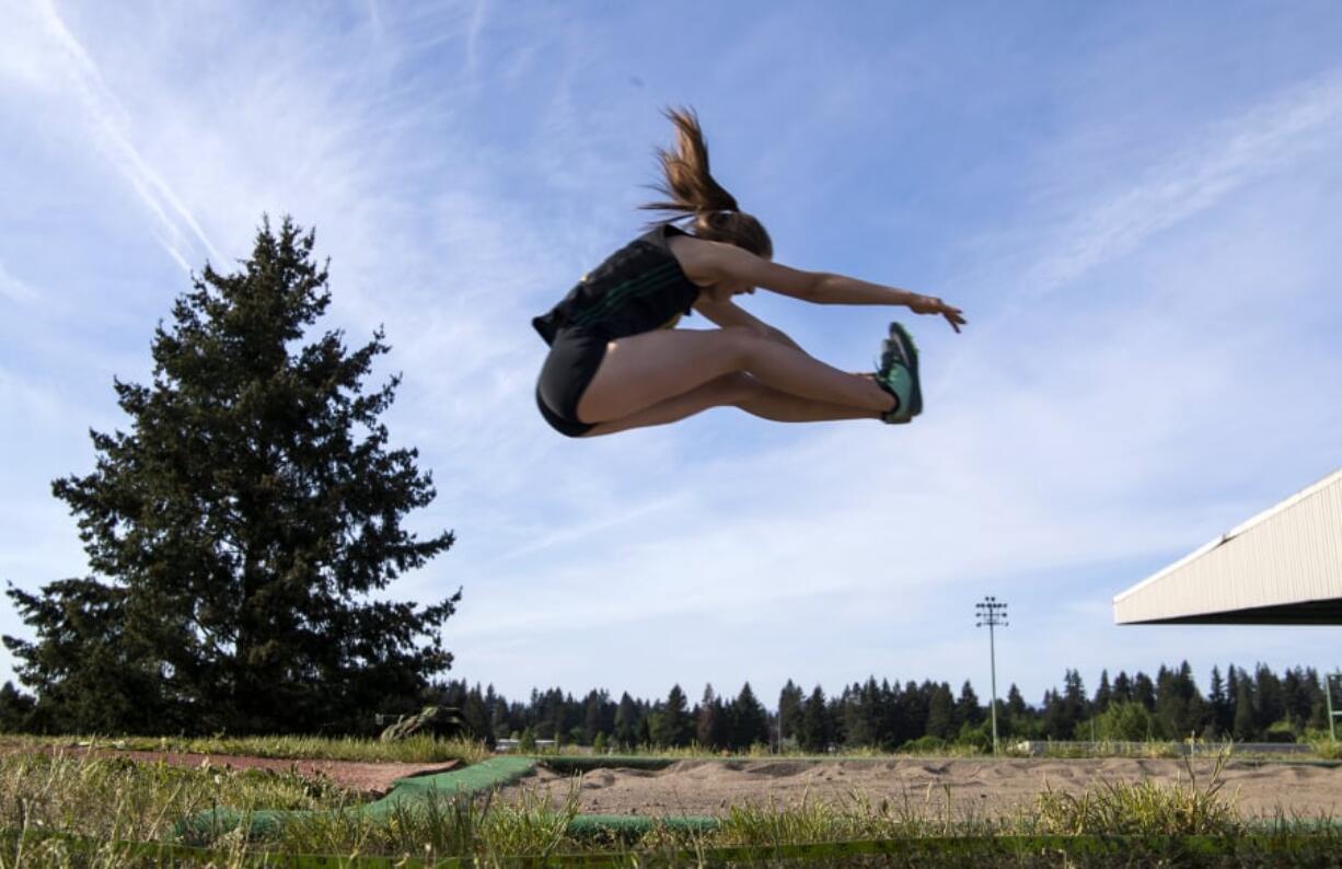 Evergreen’s Bailey Cunningham competes in the long jump during the Class 3A and 4A district track and field meet.