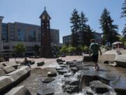 Evan Peek, 8, of Vancouver walks along the water feature in Esther Short Park.