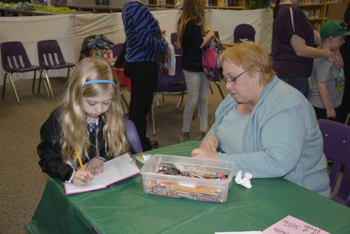 Washougal: Hathaway Elementary School second-grader Brook Woods, left, spent time with her grandmother, Vicky Kallunki, and grandfather Harold and third-grade sibling Tanner Woods, not pictured, at the first Hathaway Grand event. “I think this was a great idea,” Kallunki said. “We love the opportunity to be with our grandchildren.