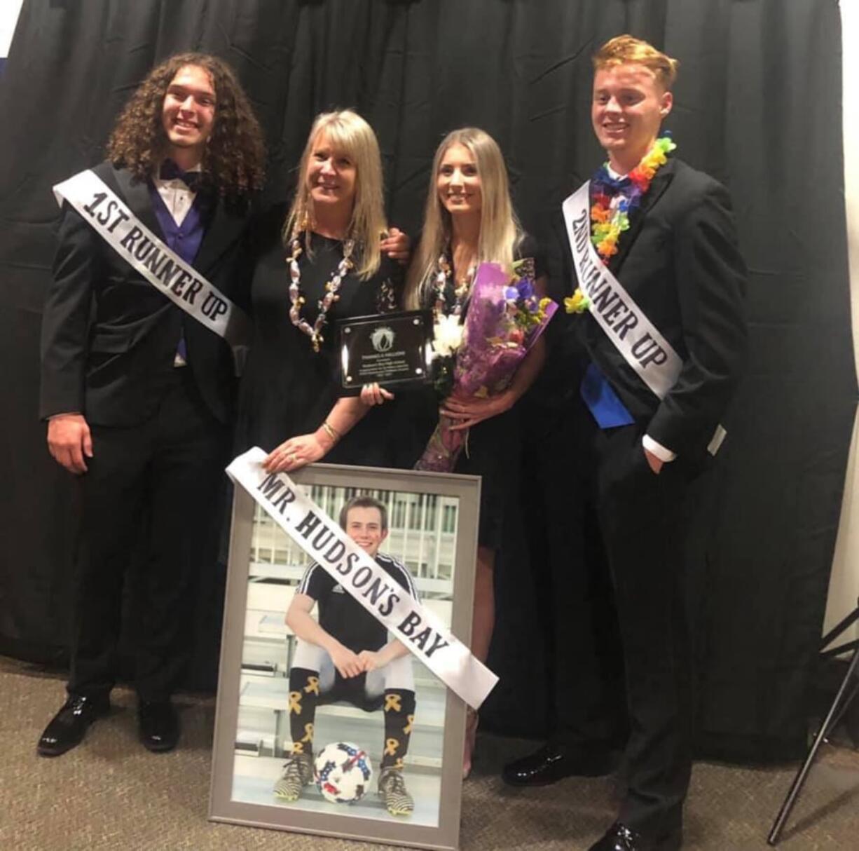 Sharyn Little, inside left, and Lauren Little, inside right, pose Saturday night after the Mr. and Ms. Hudson’s Bay mock beauty pageant and fundraiser, where their son and brother, Michael, was posthumously named Mr. Hudson’s Bay. Standing next to them are runners-up Noah Turner, left, and Trent Palen, right.