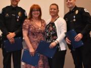 From left, Ridgefield police Officer Andrew Marvitz, Suzanne Kolle, CRESA dispatcher Julie Walker and Ridgefield police Officer Tyler King pose for a photo after being honored Thursday night by Clark County Fire & Rescue.