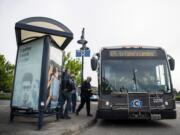 Passengers board the 65 route that travels to Fisher's Landing Transit Center in Vancouver at the Parkrose/ Sumner Transit Center in Portland, Ore., on Monday evening, May 13, 2019.