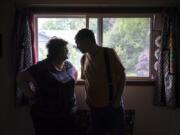 Monica Meyer, left, shares a joke with her son Michael McCormick, who has autism, while visiting him at his Vancouver home on Tuesday.