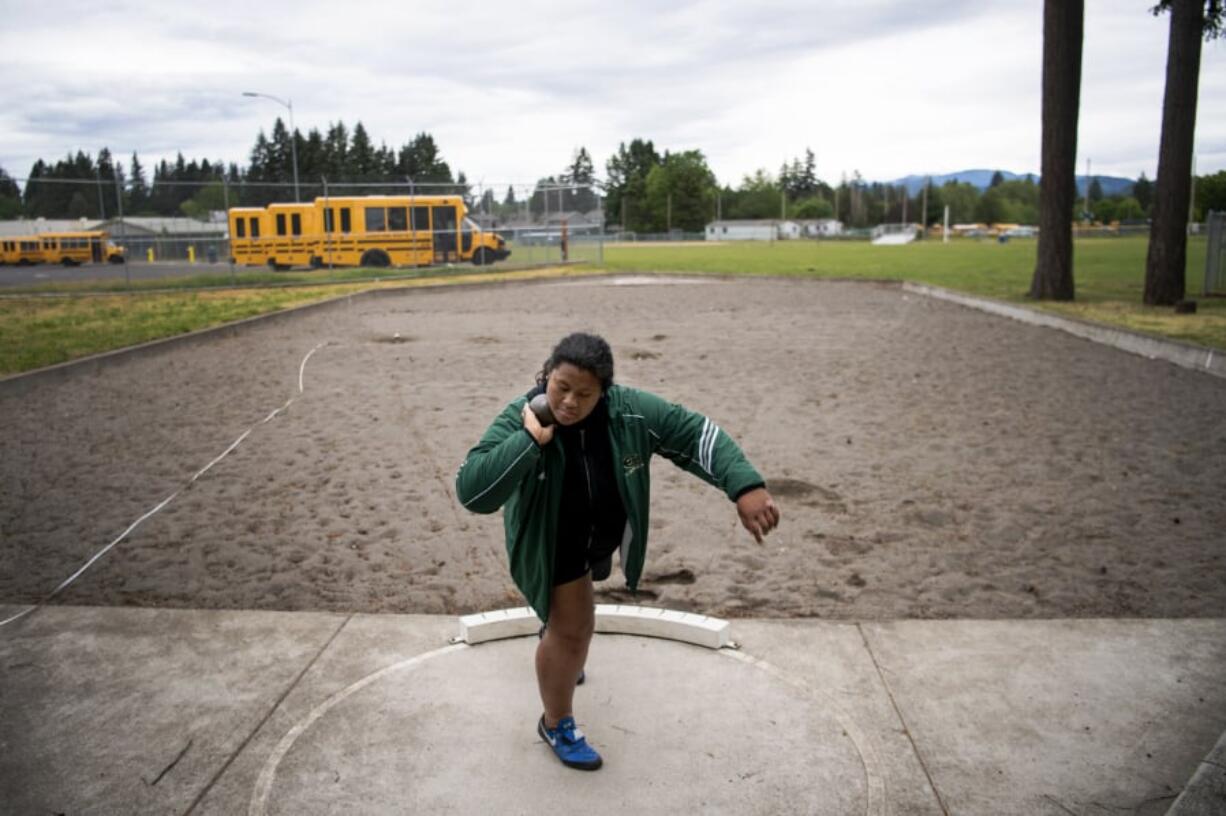 Evergreen junior Jasmine Tiatia sets up to throw during practice at McKenzie Stadium. The 3A district champion in the shot put has the top mark in 3A going into the WIAA state track and field championships this weekend.