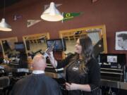 Camas resident Scott Binder stops by The Barbers to get a buzz cut and a neck shave from manager Tamie Brown.