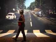 Lori Benton of Vancouver walks across an “Abbey Road” backdrop that’s provided as part of “Ladies and Gentlemen … The Beatles!” The traveling exhibit opened at the Oregon Historical Society Museum earlier this month and continues through Nov. 12.