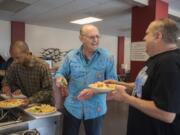 Darius Roberts, from left, a member of Recovery Cafe Clark County, makes his way through the salad bar at lunchtime as fellow member Cliff McFall shares a laugh with circle facilitator Monte Gantka. Recover Cafe Clark County offers free food to members. The cafe specializes in helping people recover from substance addiction, abuse, past trauma and more. “We don’t determine what recovery is for our members,” said Recovery Cafe Clark County Executive Director Larry Worthington.