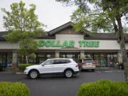A motorist passes a Dollar Tree store along Northeast 162nd Avenue on Thursday afternoon, May 16, 2019. The Washington State Department of Labor &amp; Industries announced Thursday a $503,200 fine against the store, alleging unsafe conditions.