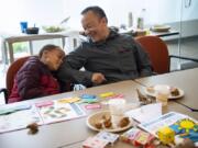 Sifton Elementary School third-grader Jayden McConnell, left, and his big brother, imaging assistant Donnie Vongthongthip, right, share a laugh during their bi-monthly Big Brothers Big Sisters of America meeting at the Kaiser Permanente Orchards office in Vancouver.