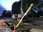 A Clark Public Utilities crew repairs a water main break Monday night on Northwest 99th Street near Northwest Ninth Avenue.