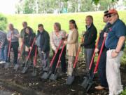 Elected officials and other dignitaries take part in a groundbreaking ceremony for two roundabouts that will be built on state Highway 14 in Washougal.