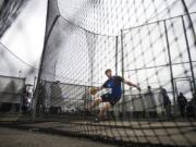 Ridgefield’s Trey Knight completes a throw to win the state title during the 2A Boys Discus Throw.