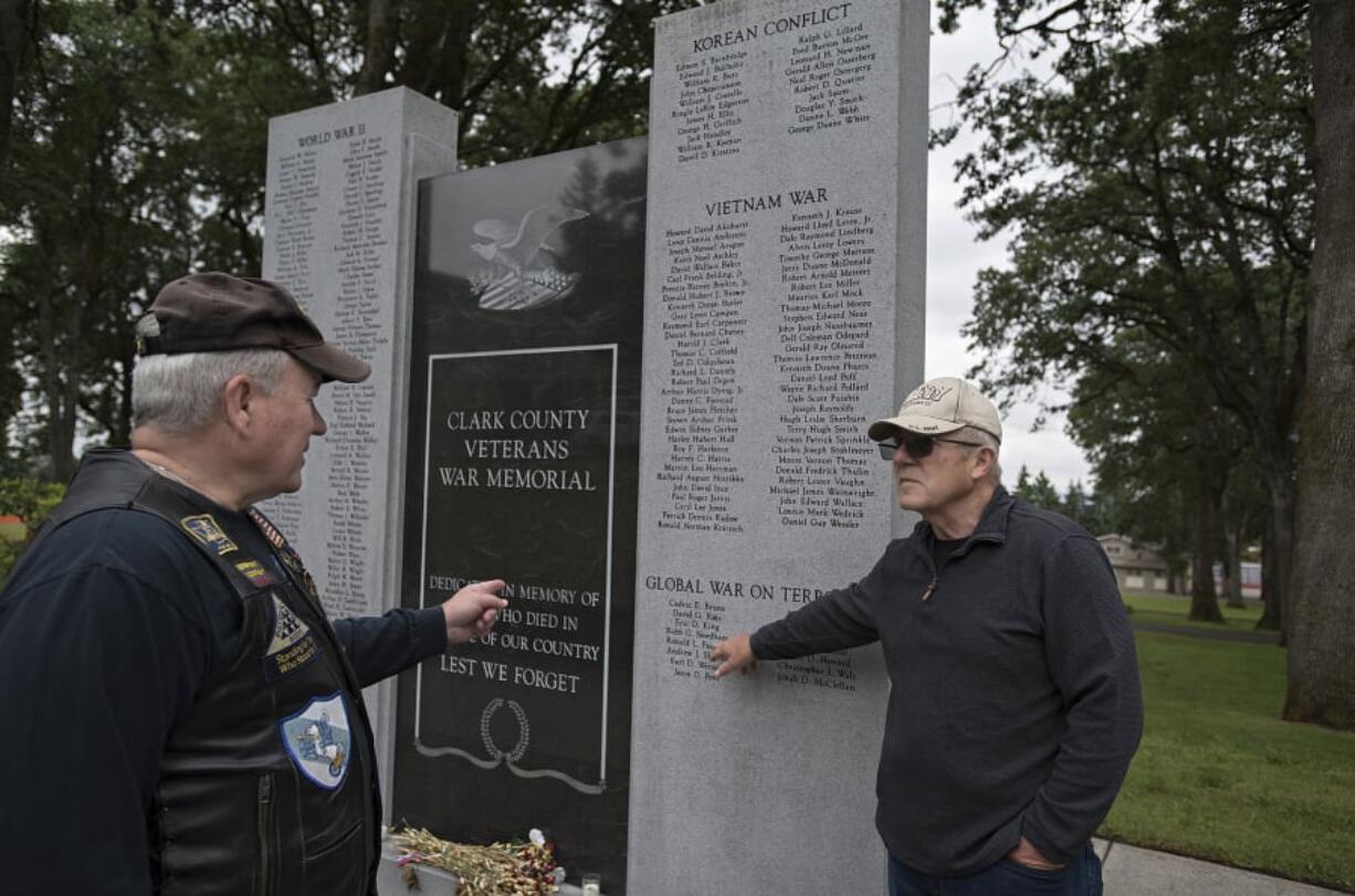 Veterans Lynn Vaughn of the Patriot Guard Riders, left, and Larry Smith of the Community Military Appreciation Committee look over the names of soldiers killed in action in post-9/11 conflicts Friday at the Clark County Veterans War Memorial. The men helped organize a series of personal memorials, called Never to be Forgotten ceremonies, for 15 fallen servicemen from Clark County.