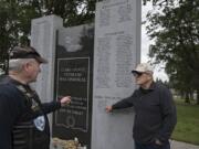 Veterans Lynn Vaughn of the Patriot Guard Riders, left, and Larry Smith of the Community Military Appreciation Committee look over the names of soldiers killed in action in post-9/11 conflicts Friday at the Clark County Veterans War Memorial. The men helped organize a series of personal memorials, called Never to be Forgotten ceremonies, for 15 fallen servicemen from Clark County.