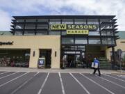 Customers walk into the New Seasons Market in Vancouver.