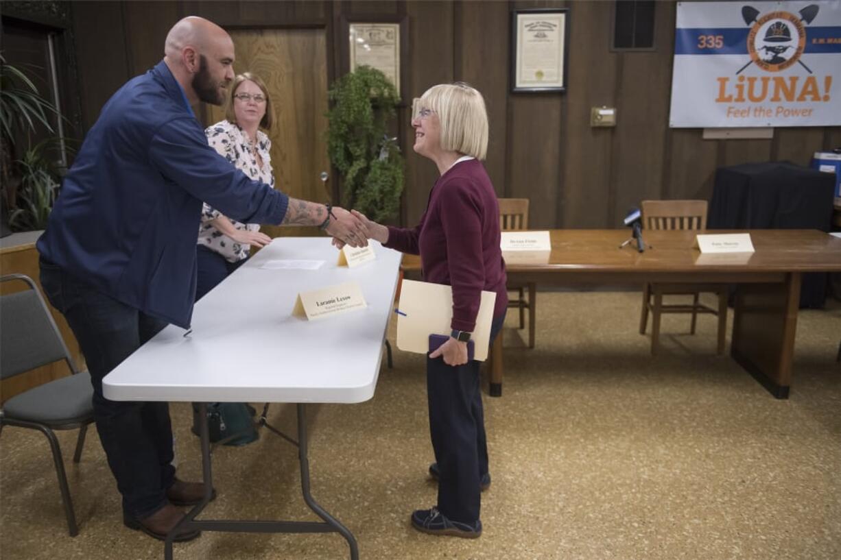 Laramie Lexow, a regional organizer with the Pacific Northwest Iron Workers District Council, from left, and Christina Daniels, a membership development representative with the International Brotherhood of Electrical Workers Local 48, meet Sen. Patty Murray, D-Wash., before a roundtable discussion at the Laborers’ International Union Hall on Wednesday.