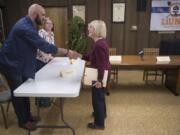 Laramie Lexow, a regional organizer with the Pacific Northwest Iron Workers District Council, from left, and Christina Daniels, a membership development representative with the International Brotherhood of Electrical Workers Local 48, meet Sen. Patty Murray, D-Wash., before a roundtable discussion at the Laborers’ International Union Hall on Wednesday.