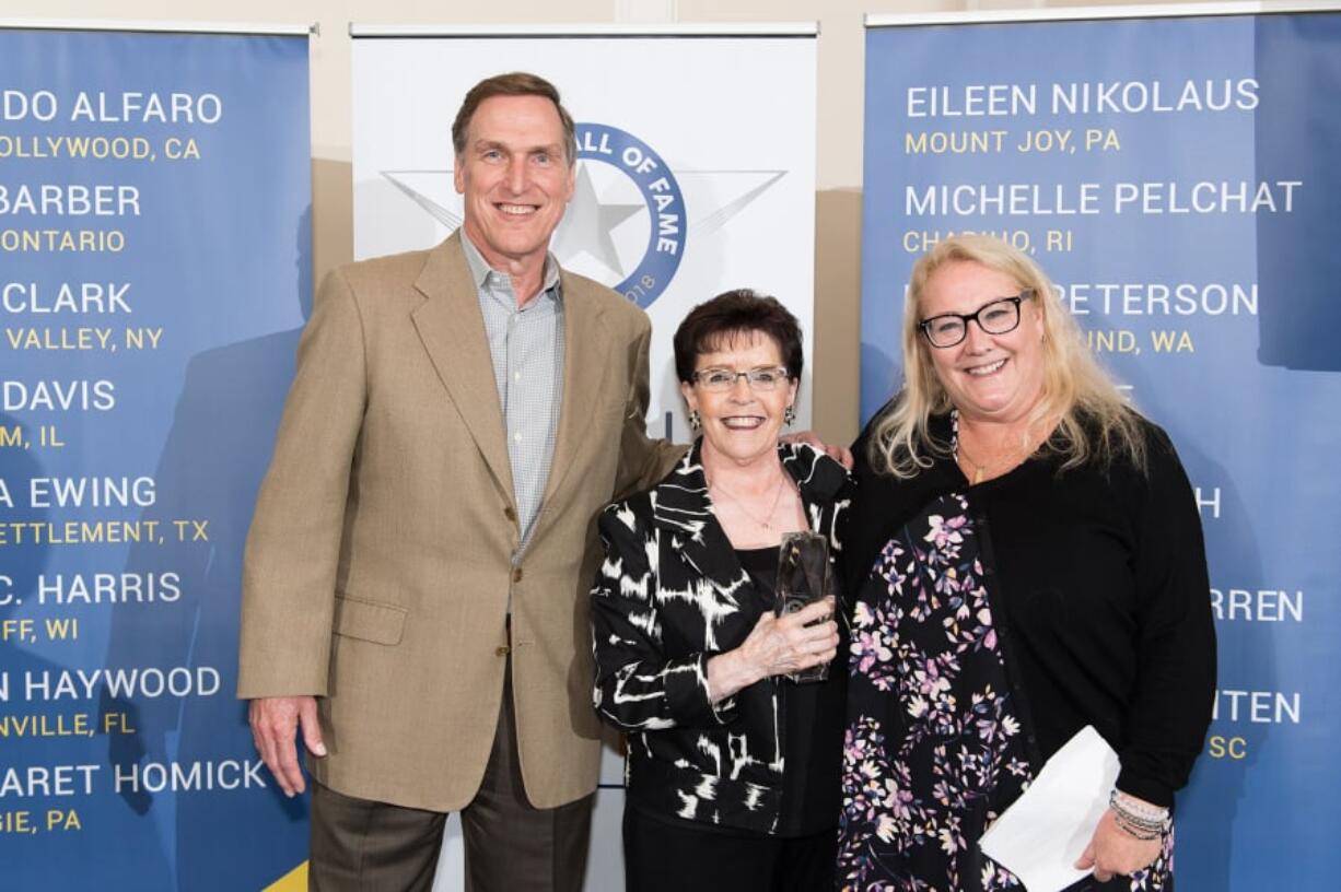 Battle Ground: From left: Don Kissell, Student Transportation of America’s senior vice president of the western region, Helen Peterson, Safety Wall of Fame inductee, and Marjorie Hatt, human resources director of the western region of the transportation agency, induct Peterson to the Wall of Fame.