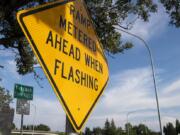 Metered ramp warnings are posted just off of Washington Street at the beginning of the I-5 onramp before the Interstate 5 Bridge in Vancouver on Thursday, May 30, 2019.