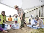 Mike Twist leads a mock archaeology dig that a small group of kids participated in at the Fort Vancouver National Historic Site.