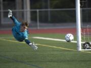 Sehome Goalkeeper Mason Kealy dives for and misses a shot on goal by Columbia River that would bonce off the goalpost during the WIAA 2A Championship title game at Sumner High School on Saturday afternoon, May 25, 2019 (Nathan Howard/The Columbian)