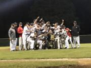 Camas players celebrate winning the 4A bidistrict title Saturday night.