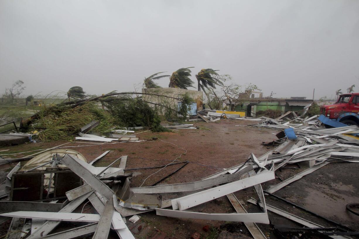 Damaged structures and uprooted tress lie along a road in Puri district after Cyclone Fani hit the coastal eastern state of Odisha, India, Friday, May 3, 2019. Cyclone Fani tore through India's eastern coast on Friday as a grade 5 storm, lashing beaches with rain and winds gusting up to 205 kilometers (127 miles) per hour and affecting weather as far away as Mount Everest as it approached the former imperial capital of Kolkata.