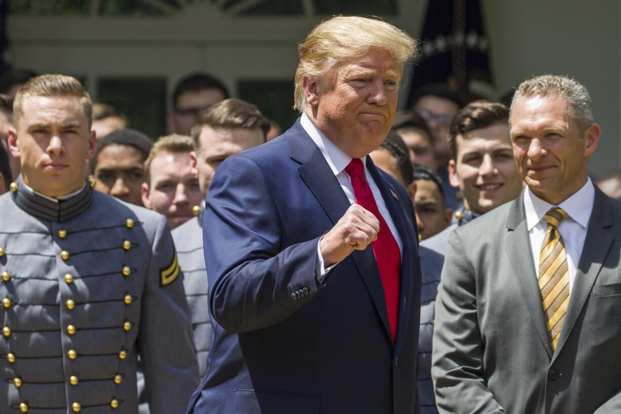 President Donald Trump pumps his fist as he departs after the presentation of the Commander-in-Chief's Trophy to the U.S. Military Academy at West Point football team, in the Rose Garden of the White House, Monday, May 6, 2019, in Washington.