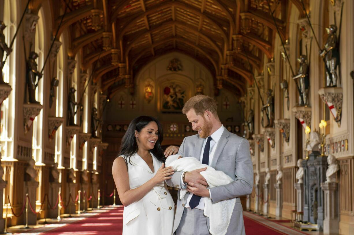 Britain's Prince Harry and Meghan, Duchess of Sussex, during a photocall with their newborn son, in St George's Hall at Windsor Castle, Windsor, south England, Wednesday May 8, 2019. Baby Sussex was born Monday at 5:26 a.m. (0426 GMT; 12:26 a.m. EDT) at an as-yet-undisclosed location. An overjoyed Harry said he and Meghan are "thinking" about names.