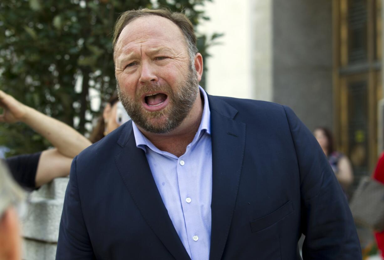 FILE- In this Sept. 5, 2018, file photo conspiracy theorist Alex Jones speaks outside of the Dirksen building of Capitol Hill in Washington. A federal judge will let a jury decide whether conspiracy theorist Alex Jones’ Infowars website had a legal right to sell a poster featuring the image of Pepe the Frog, a character that became hijacked by far-right extremists. U.S.