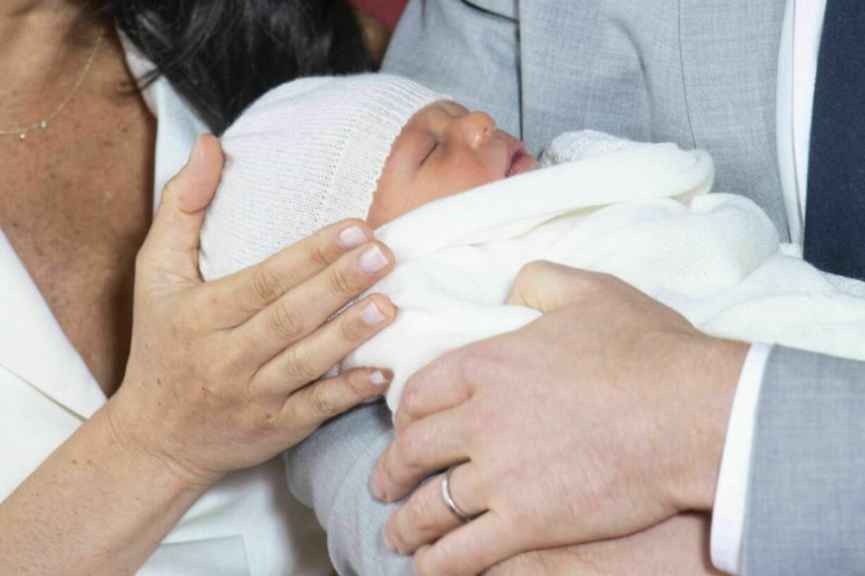 Britain’s Prince Harry and Meghan, Duchess of Sussex, during a photocall with their newborn son, in St George’s Hall at Windsor Castle, Windsor, south England, Wednesday May 8, 2019. Baby Sussex was born Monday at 5:26 a.m. (0426 GMT; 12:26 a.m. EDT) at an as-yet-undisclosed location. An overjoyed Harry said he and Meghan are “thinking” about names.